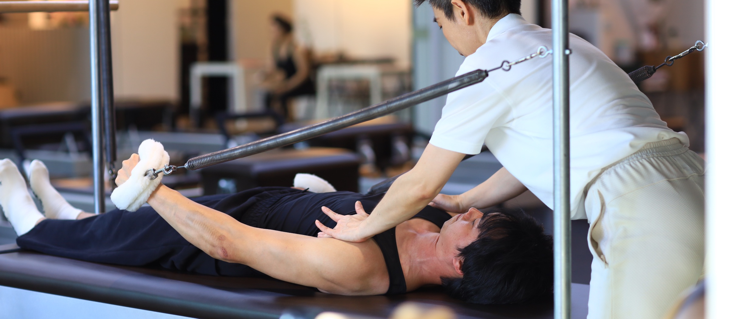 Teacher and student in a Classical Pilates session at RM58