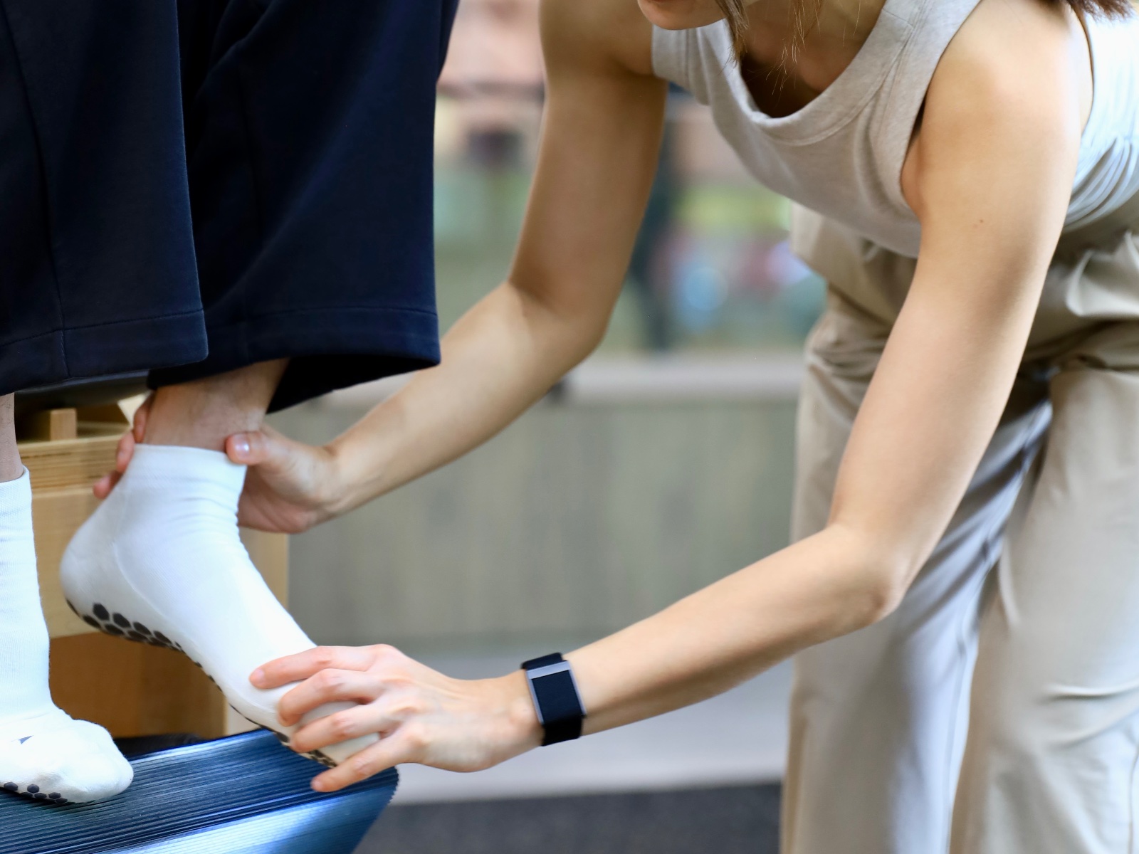 Kru Ice guiding a student on the apparatus